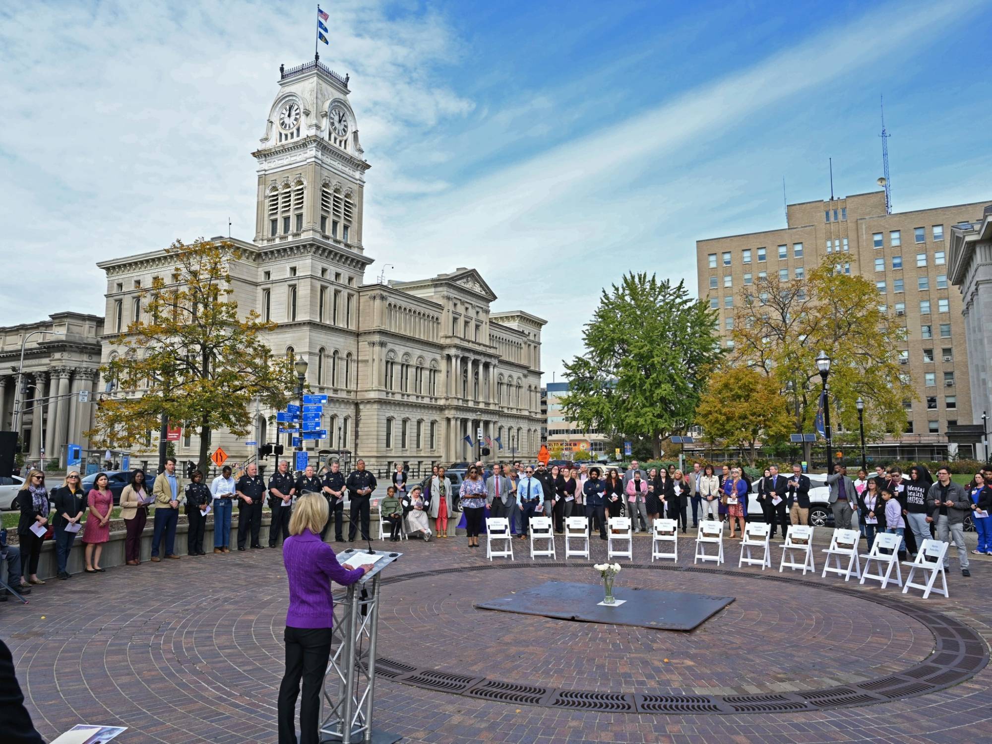 Photo of Elizabeth Martin, President of The Center for Women and Families, speaking at the 2023 Speak Their Names event at Jefferson Square Park.
